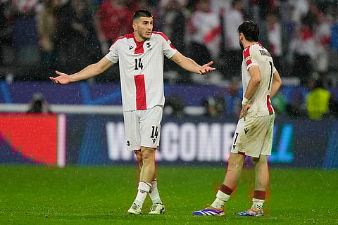 Luka Lochoshvili, left, talks to Khvicha Kvaratskhelia